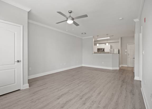 A room with a ceiling fan and light fixture.