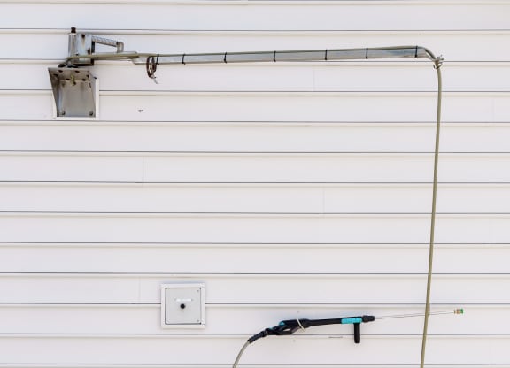 a hose plugged into the side of a garage door at Orleans Apartments, Ohio