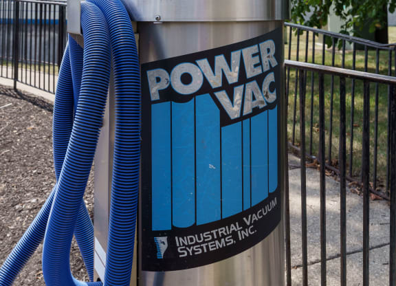a power vac container with a blue hose plugged into it at Orleans Apartments, Columbus