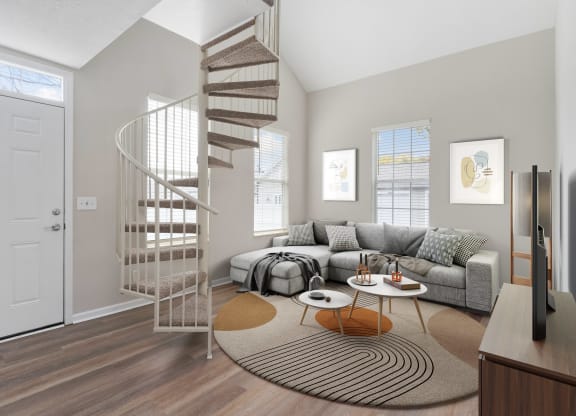 a spiral staircase in a living room with a couch at Orleans Apartments, Columbus, Ohio