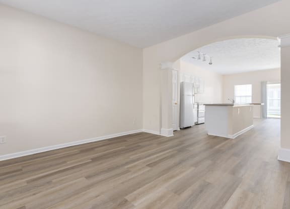 an empty living room and kitchen with white walls and wood flooring at Orleans Apartments Apartments, Columbus, OH, 43221