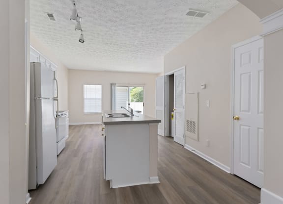 an empty kitchen with a sink and a refrigerator at Orleans Apartments Apartments, Columbus, OH