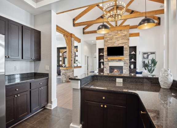 a kitchen with granite counter tops and a fireplace