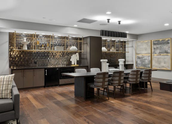 a dining room with a large table and chairs and a kitchen with a bar at Preston Centre, Ohio, 43215