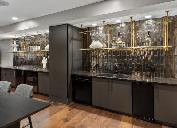 a kitchen with dark cabinets and a table with chairs at Preston Centre, Columbus, 43215