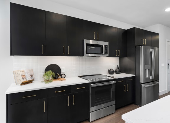 a kitchen with black cabinets and white countertopsat Preston Centre, Ohio