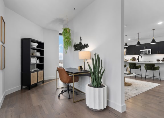 a home office with a desk and chair and a kitchen in the backgroundat Preston Centre, Columbus