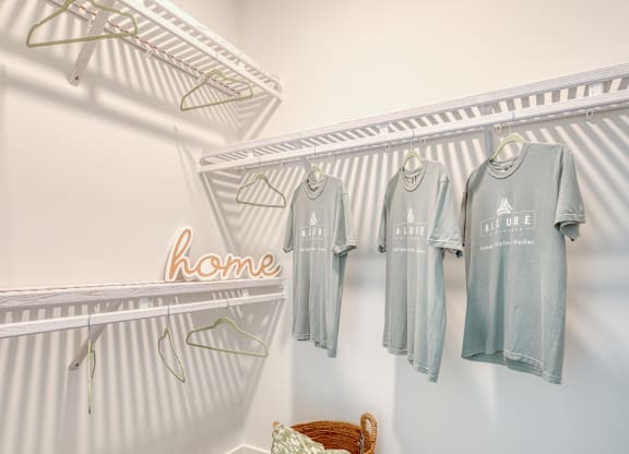 a laundry room with four shirts hanging on the wall at Allure at Edinburgh, Virginia, 23322