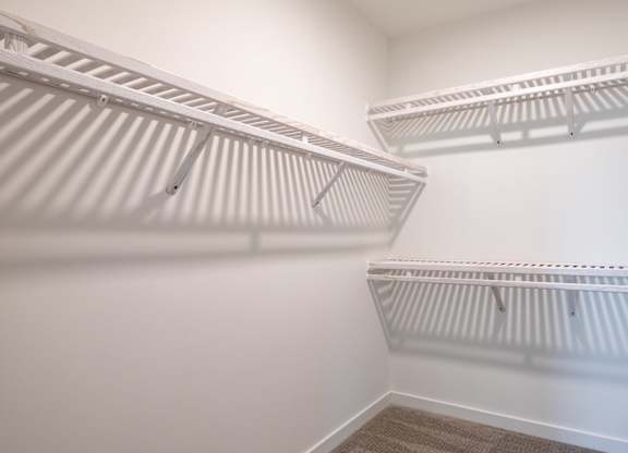 Empty white shelves in a room.