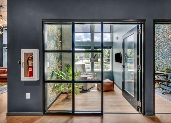 A modern interior with a glass door leading to a balcony.