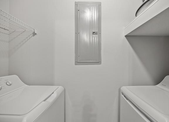 A white washing machine and dryer in a small laundry room.