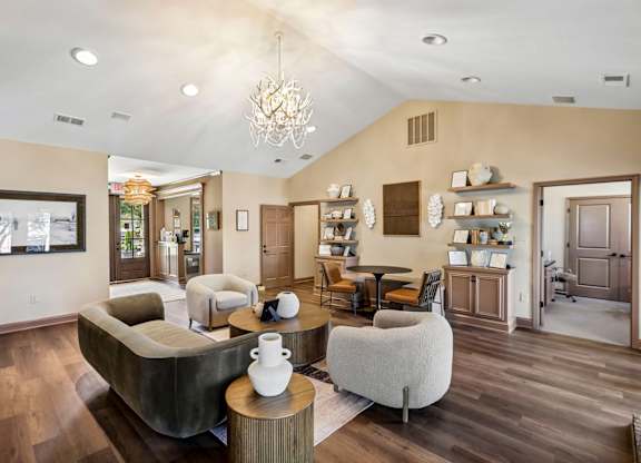 A living room with a grey couch and a wooden coffee table.