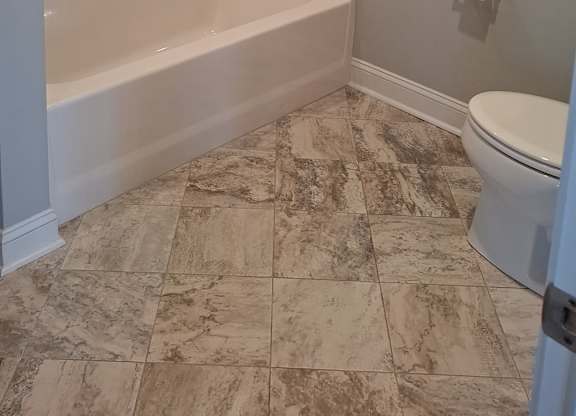 a bathroom with a toilet and a bath tub