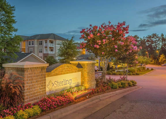 Sterling sign in front of a building with flowers.