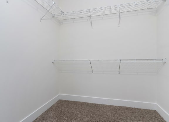 a room with white walls and a carpet and a white closet at Strathmoor Apartments , Dublin, Ohio