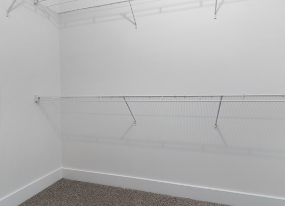 a room with a white wall and a hanging rack on the ceiling at Strathmoor Apartments , Dublin, Ohio