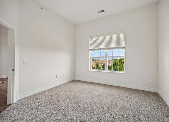 A room with a window overlooking a cityscape.