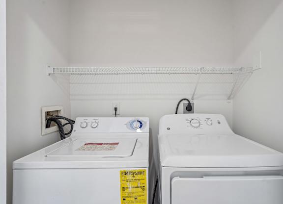 A small laundry room with a washer and dryer.