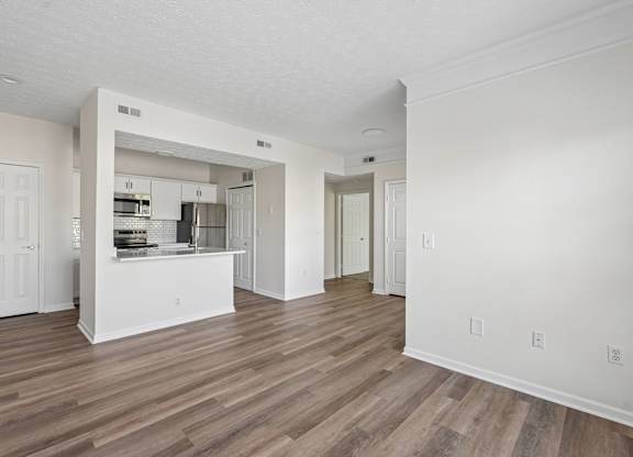 A kitchen with white cabinets and a white island with a sink.