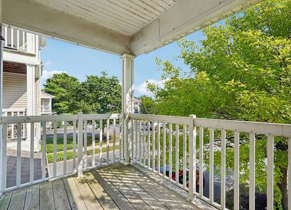 A white railing on a wooden deck.