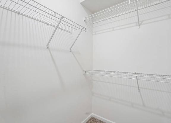 Empty white shelves in a room.
