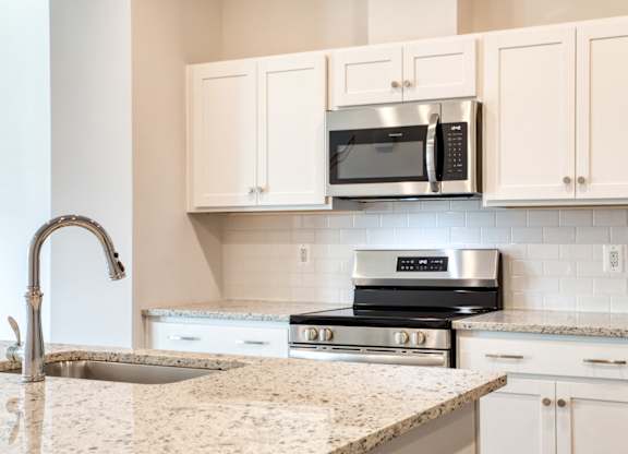 Kitchen White cabinetry and tile backsplash at The Mark, Harrisonburg, VA
