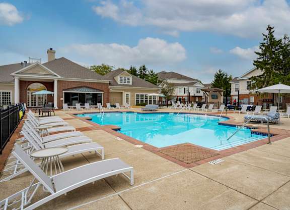 A pool with sun loungers in front of a building. at The Orchard, Dublin