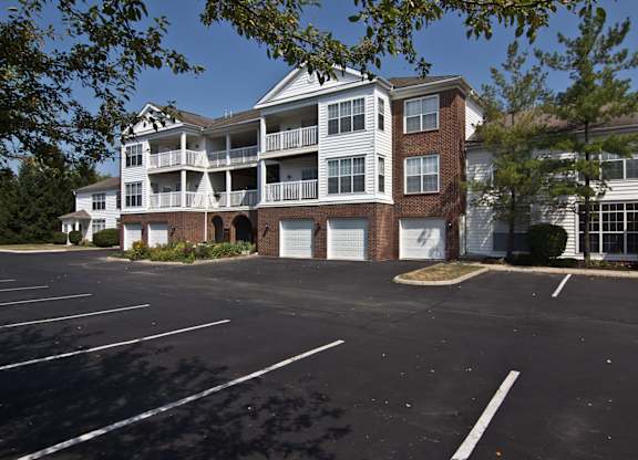 A parking lot in front of a two story apartment building. at The Orchard, Dublin, 43016
