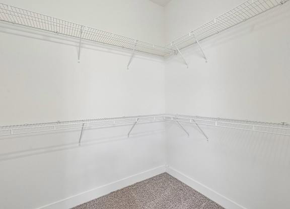 Empty room with white walls and a carpeted floor.
