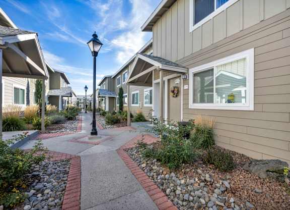 Street lamp stands in the middle of pathway between houses at Peaks at the Park, Reno