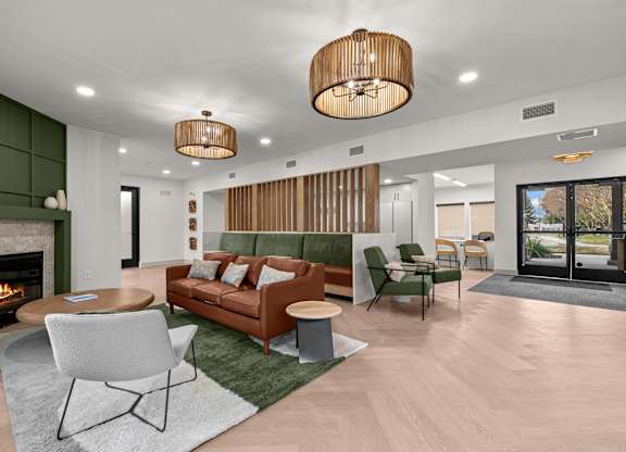 A modern living room with a fireplace and a sofa.