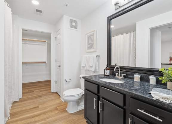 A bathroom with a white toilet and a sink.