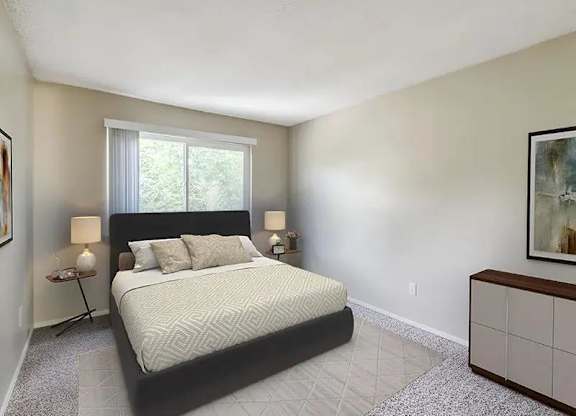A bedroom with a large bed and a window.