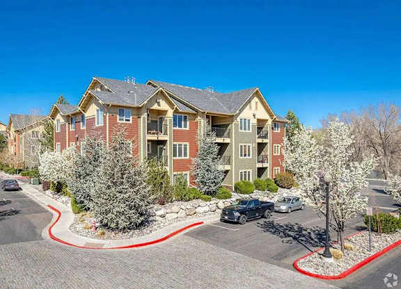 A large apartment complex with a red border around the parking lot.
