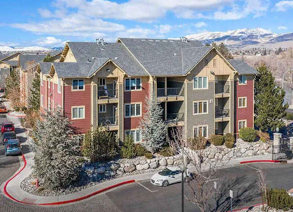 Apartment complex with a car parked in front.