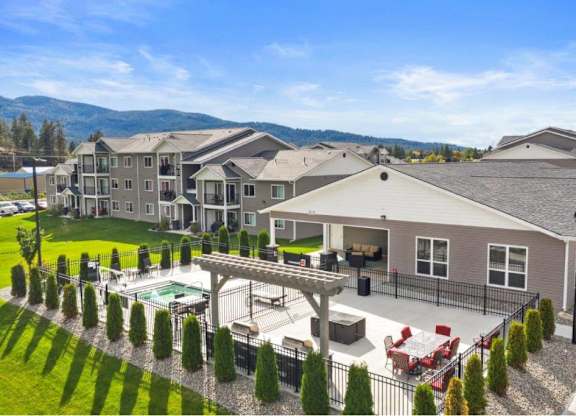 A large house with a pool and a mountain in the background.