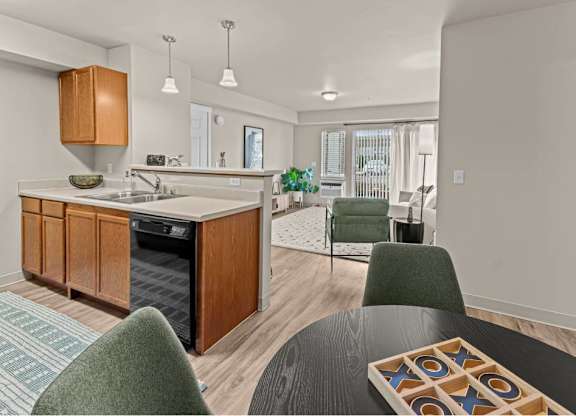 A modern kitchen with wooden cabinets and a black dining table.