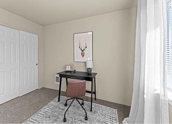 A room with a desk and a chair.