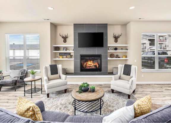 A cozy living room with a fireplace and seating area.