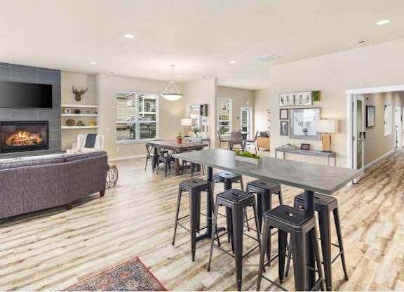 A modern living room with a fireplace and a dining area.