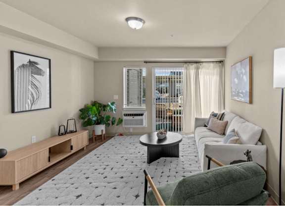 A living room with a green chair and a grey sofa.
