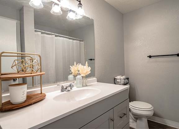 A bathroom with a white toilet and a white sink.