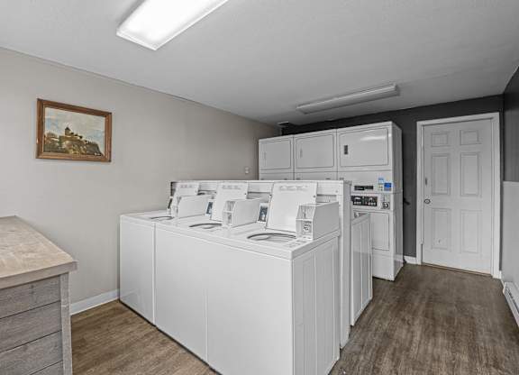 A laundry room with a washer and dryer stacked on top of each other.