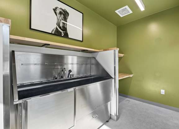 A kitchen with a stainless steel counter and a fridge.
