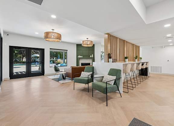 A modern living room with a green chair in the center.