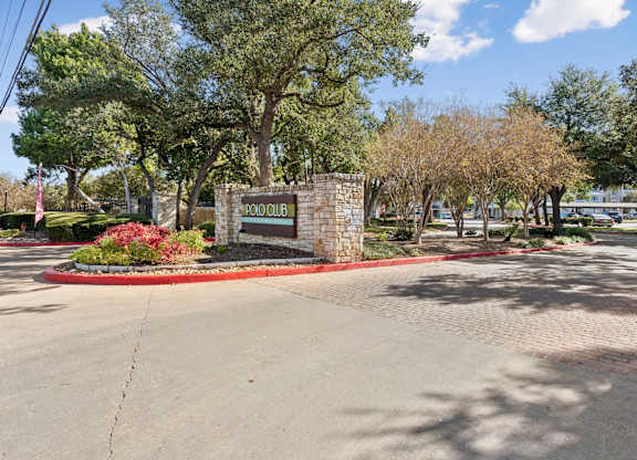 Stone monument sign at community entrance at Polo Club Apartments, Austin, TX 78729