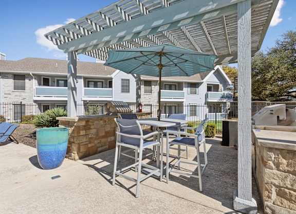Outdoor grilling station with covered dining pergola at Polo Club Apartments, Austin, 78729