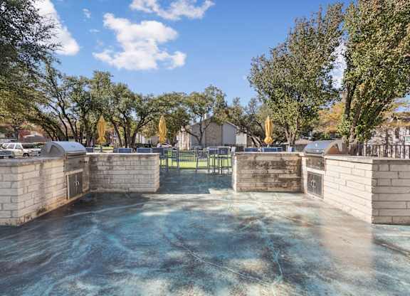 Empty concrete pool basin with brick pillars at Polo Club Apartments, Austin