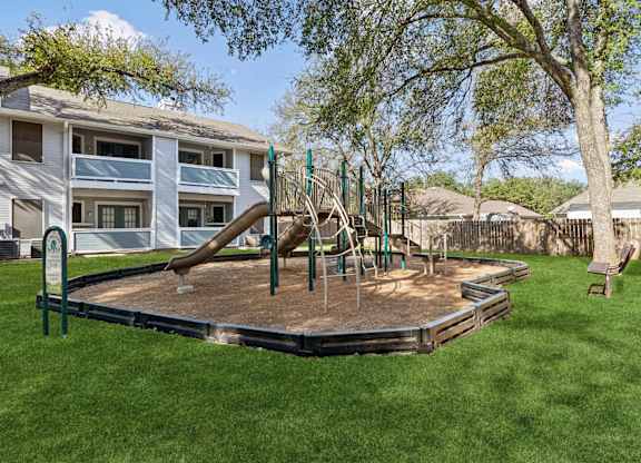 Childrens playground with slides and climbing equipment at Polo Club Apartments, Austin, TX