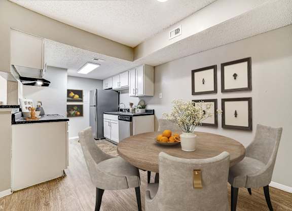 Dining room with round table and gallery wall at Peaks at Universal City Apartments, Universal City, 78148